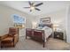 Main bedroom with king-size bed and leather armchair at 8995 Milestone Dr, Sarasota, FL 34238