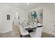 Dining room with modern glass table and white chairs at 8995 Milestone Dr, Sarasota, FL 34238