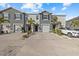 Two-story townhome with gray exterior, two-car garage, and landscaping at 8995 Milestone Dr, Sarasota, FL 34238