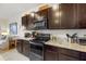 Modern kitchen with dark brown cabinets, granite countertops, and stainless steel appliances at 8995 Milestone Dr, Sarasota, FL 34238