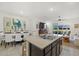 Modern kitchen with island, granite countertops, and view of living room at 8995 Milestone Dr, Sarasota, FL 34238