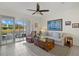 Bright and airy living room with sliding doors to screened patio at 8995 Milestone Dr, Sarasota, FL 34238