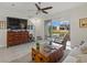 Living room with sliding doors leading to a patio overlooking a pond at 8995 Milestone Dr, Sarasota, FL 34238