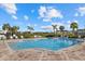 Community pool with lounge chairs and a large patio area at 8995 Milestone Dr, Sarasota, FL 34238