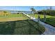 Lush lawn and dockside access features a well-maintained wooden walkway and inviting waterfront appeal at 9464 St Marys Ct, Port Charlotte, FL 33981