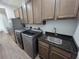 Laundry room features stainless steel appliances, cabinets, and a granite countertop sink at 9464 St Marys Ct, Port Charlotte, FL 33981