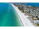 Panoramic aerial view of a coastline featuring white sandy beaches and turquoise ocean waters at 951 Contento St., Siesta Key, FL 34242