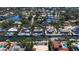 The aerial shot captures a neighborhood set amidst winding canals, revealing many homes with boat access and backyard pools at 951 Contento St., Siesta Key, FL 34242