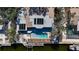 Aerial view of the roof showcases solar panels, and a pool next to a canal with boat lift at 951 Contento St., Siesta Key, FL 34242