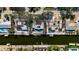 An aerial view shows homes along a canal, highlighting waterfront living with boat docks and backyard pools at 951 Contento St., Siesta Key, FL 34242