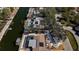 Aerial perspective of the property featuring a pool, boat lift, and waterfront access at 951 Contento St., Siesta Key, FL 34242