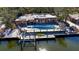 An elevated angle shows the backyard, solar panels, boat lift, and canal access, providing a waterfront lifestyle at 951 Contento St., Siesta Key, FL 34242