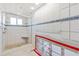 Bathroom features a glass shower with tiled walls and trim, a bench, and a shower head at 951 Contento St., Siesta Key, FL 34242