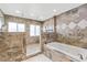 Beautiful bathroom featuring a soaking tub and walk-in shower with tile floors and walls at 951 Contento St., Siesta Key, FL 34242