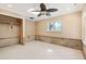 Spacious bedroom features tile flooring, a ceiling fan and natural light from the window and skylight at 951 Contento St., Siesta Key, FL 34242