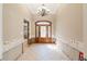 Elegant foyer features a decorative wood door, a chandelier, and tile flooring at 951 Contento St., Siesta Key, FL 34242