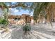 View of the home's facade with neutral tones. The home is framed by foliage creating a sense of privacy at 951 Contento St., Siesta Key, FL 34242