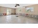 Bright living room featuring tile floors, ceiling fan, and a sliding glass door that leads to an outdoor patio at 951 Contento St., Siesta Key, FL 34242