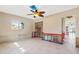 Bright living room featuring tile floors, ceiling fan, and natural light from a window at 951 Contento St., Siesta Key, FL 34242