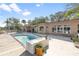 Backyard pool with a wooden deck is an ideal spot for leisure activities with lush trees providing shade around the house at 951 Contento St., Siesta Key, FL 34242