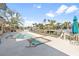 Backyard view of the empty inground pool and hot tub with a canal view in the background at 951 Contento St., Siesta Key, FL 34242