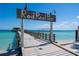 Picturesque Rod Reel Pier featuring a wooden walkway over clear turquoise waters on a sunny day at 951 Contento St., Siesta Key, FL 34242