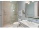 Bathroom with beige tile, glass shower, and a pedestal sink at 1067 Westway Dr, Sarasota, FL 34236