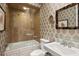 Bathroom with beige tile, glass shower, and a built-in bathtub at 1067 Westway Dr, Sarasota, FL 34236