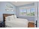 Guest bedroom with a white queen bed and blue and white decor at 1067 Westway Dr, Sarasota, FL 34236