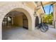 Elegant home exterior with arched entryway and bike storage at 1067 Westway Dr, Sarasota, FL 34236
