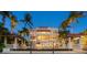 Beautiful home exterior with lush landscaping and lighting at 1067 Westway Dr, Sarasota, FL 34236