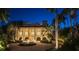 Grand estate at night with palm trees and fountain at 1067 Westway Dr, Sarasota, FL 34236