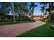 Grand estate entrance with brick driveway and palm trees at 1067 Westway Dr, Sarasota, FL 34236