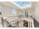 Elegant two-story foyer with a skylight and sweeping staircase at 1067 Westway Dr, Sarasota, FL 34236