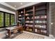 Spacious home office with built-in bookshelves and a large desk at 1067 Westway Dr, Sarasota, FL 34236