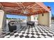 Covered patio with seating area, dining table, and checkered floor at 1067 Westway Dr, Sarasota, FL 34236