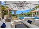 Relaxing pool area with comfortable seating and umbrellas at 1067 Westway Dr, Sarasota, FL 34236