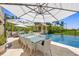 Spacious poolside dining area with large table and chairs at 1067 Westway Dr, Sarasota, FL 34236