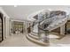 Grand curved staircase with marble steps and wrought iron railings at 1067 Westway Dr, Sarasota, FL 34236