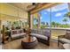 Relaxing sunroom with wicker furniture and ocean views at 1067 Westway Dr, Sarasota, FL 34236