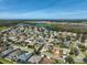 A scenic aerial view of a residential community with lush landscaping and beautiful lake views at 10726 Old Grove Cir, Bradenton, FL 34212
