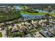 An elevated view of a golf community with serene water features amid colorful houses and abundant greenery at 10726 Old Grove Cir, Bradenton, FL 34212