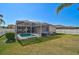 Lush backyard featuring a screened-in pool and well-maintained lawn at 10726 Old Grove Cir, Bradenton, FL 34212