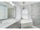 This bathroom features marble-look shower and tub, white countertops, and modern fixtures at 10726 Old Grove Cir, Bradenton, FL 34212