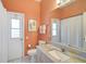 Bathroom features a granite countertop, white cabinets, and modern fixtures at 10726 Old Grove Cir, Bradenton, FL 34212