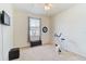 Spare bedroom with neutral walls, a mounted TV, and a window for ample natural light at 10726 Old Grove Cir, Bradenton, FL 34212