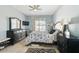 The bedroom is well-lit with sleek black furnishings, a ceiling fan, and tile floors at 10726 Old Grove Cir, Bradenton, FL 34212