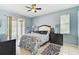 This main bedroom has tile floors, a ceiling fan, and sliding glass door access to the screened patio at 10726 Old Grove Cir, Bradenton, FL 34212