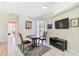 Bright dining area boasts tile flooring and a modern entertainment center at 10726 Old Grove Cir, Bradenton, FL 34212