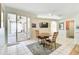 Bright dining area features tile floors, sliding glass doors to the patio, and a ceiling fan at 10726 Old Grove Cir, Bradenton, FL 34212